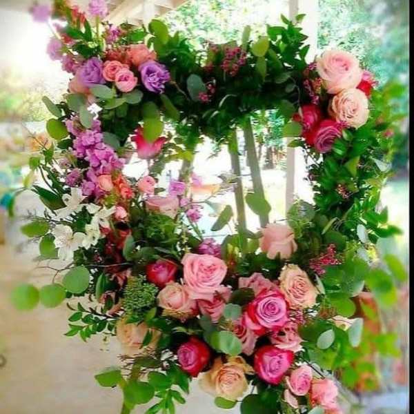 Heart-shaped floral wreath with pink and purple roses and greenery