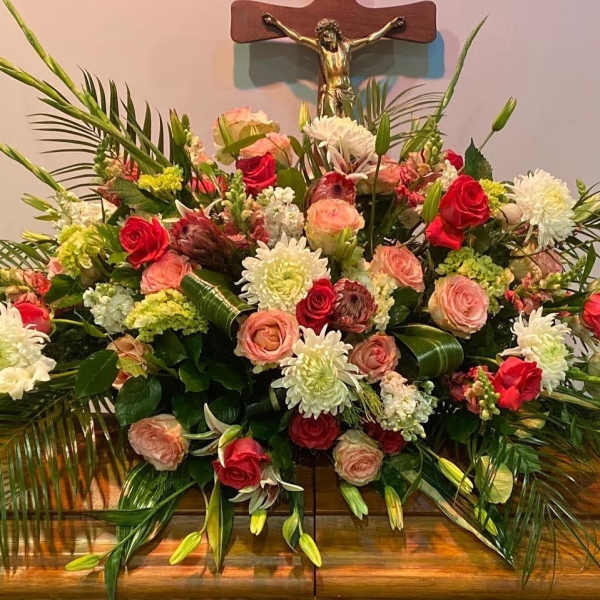 Large floral arrangement with red and blush roses and white blooms