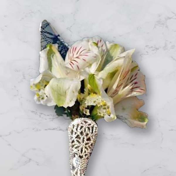 White and pale pink floral boutonniere with a jeweled cone holder