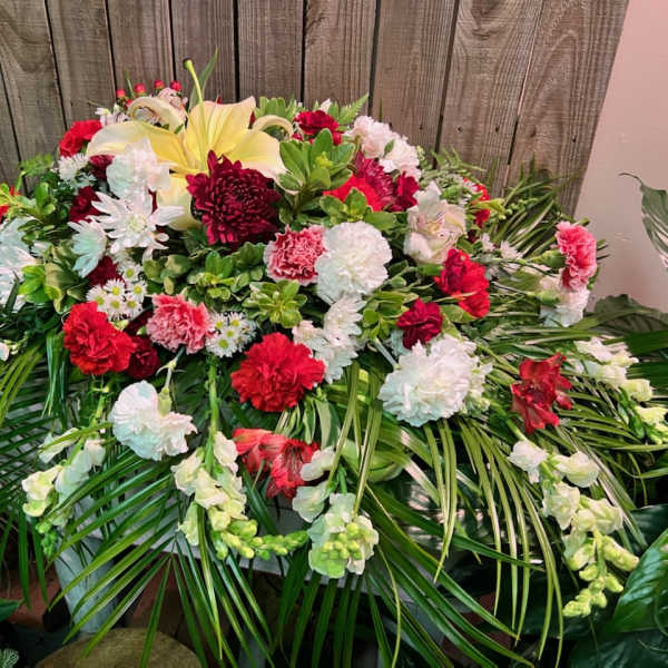 Large red, white, and yellow floral spray with palm fronds
