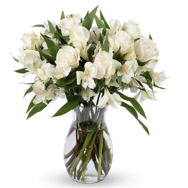 White roses and alstroemeria in a clear glass vase