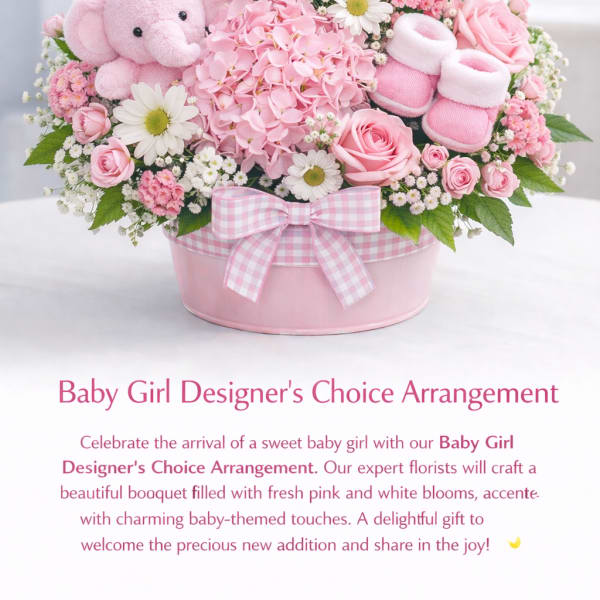 Pink and white baby girl flower arrangement with a teddy bear and booties