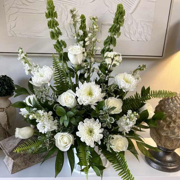 White roses and chrysanthemums in a vase with tall green spikes