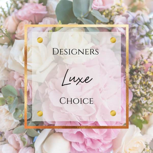 Pastel pink and white floral arrangement with gold-framed text overlay
