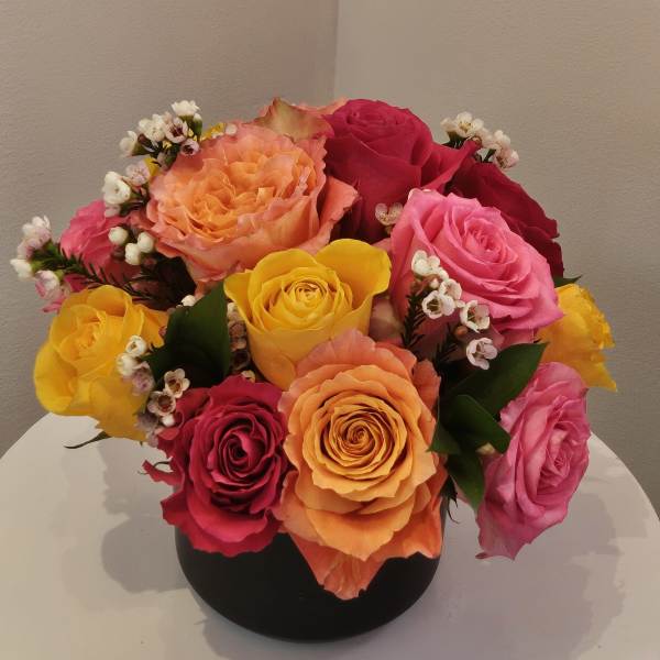 Colorful rose bouquet in a black vase