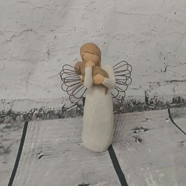 Small angel figurine holding a lamb