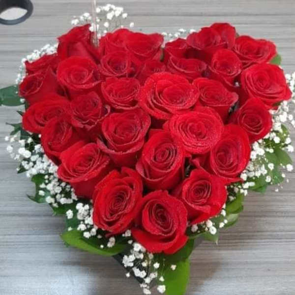 Heart-shaped bouquet of red roses with baby's breath