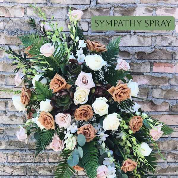 Sympathy spray with roses and orchids in soft neutral tones