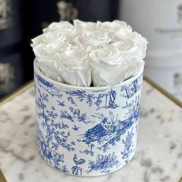 White roses arranged in a blue-and-white round box