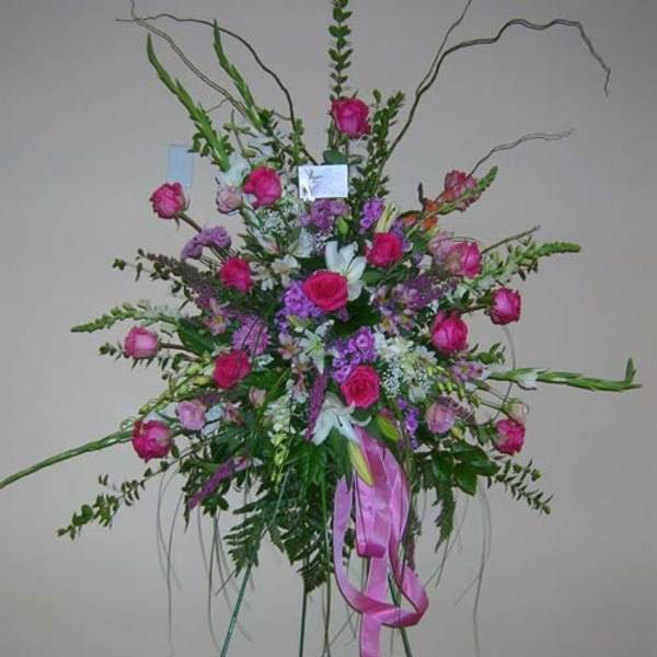 Tall pink and purple floral spray with ribbon accents