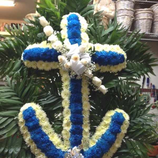 Blue and white floral cross wreath with white ribbon accents