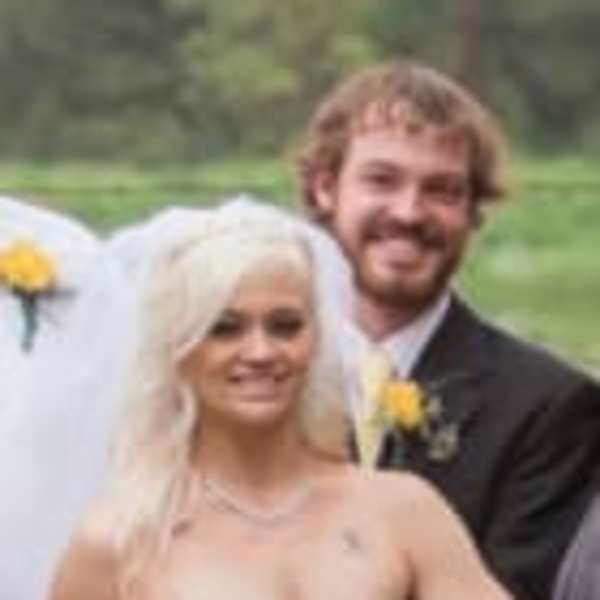 Bride holding a white and yellow wedding bouquet