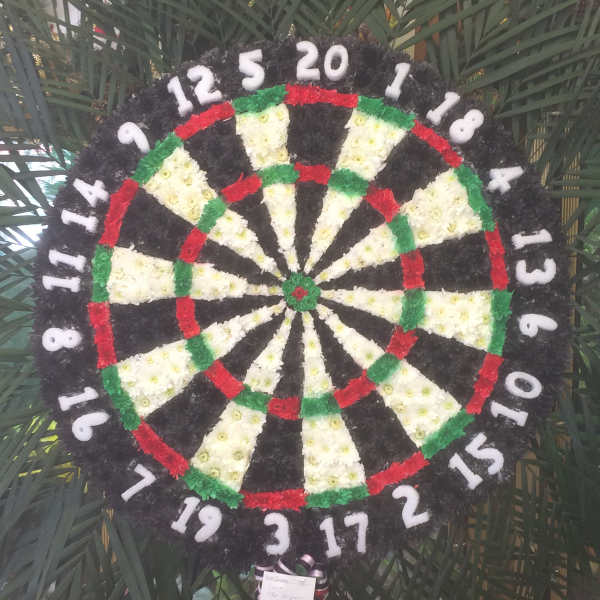 Circular floral wreath designed like a dartboard with white numbers around the edge.