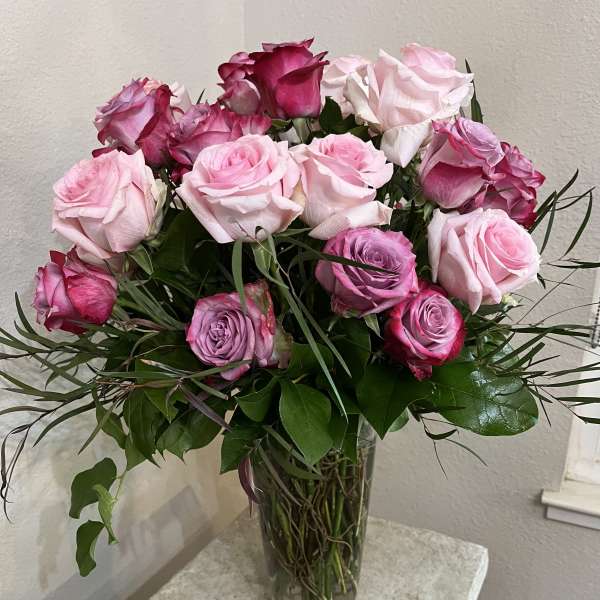 Bouquet of pink and white roses in a clear glass vase