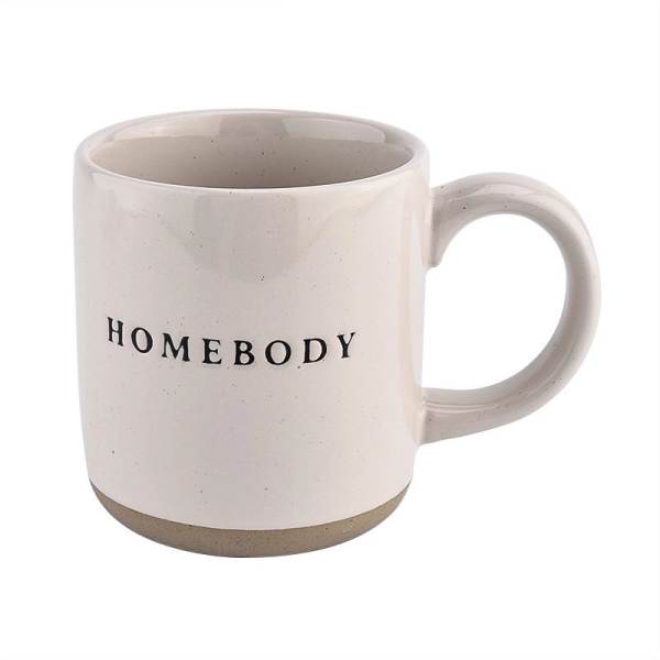 Cream ceramic mug with the word "HOMEBODY" printed on it