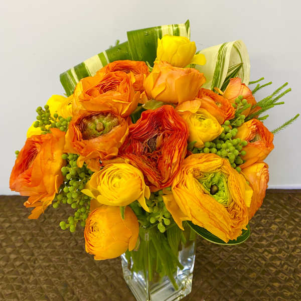 Orange and yellow bouquet in a clear glass vase