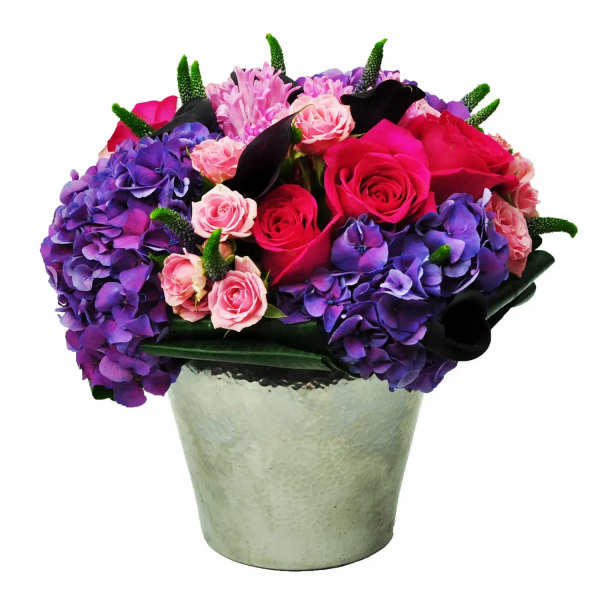 Bouquet of pink roses and purple hydrangeas in a silver vase