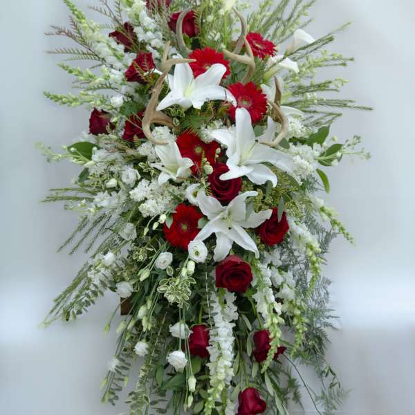 Tall red and white floral spray with lilies and roses