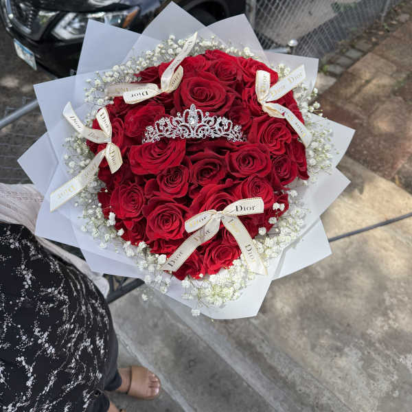 Bouquet of red roses with white baby's breath and a tiara topper