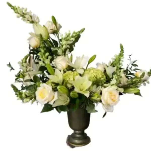 White floral arrangement in a dark urn vase