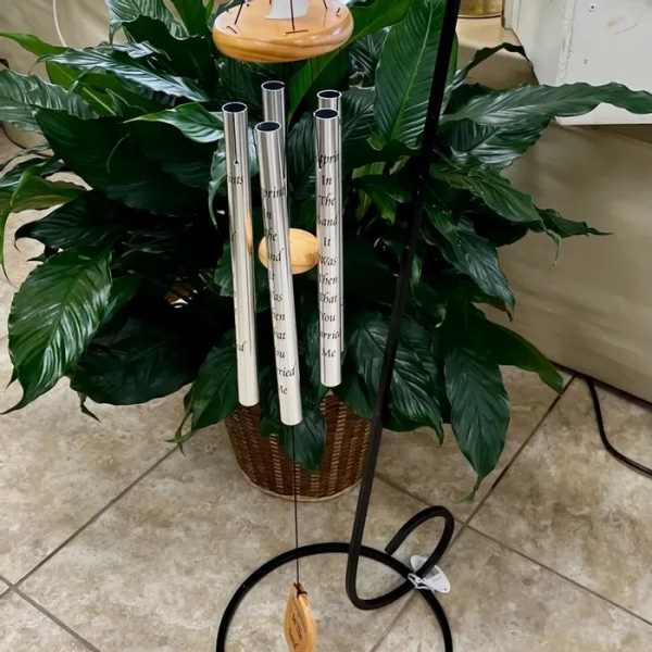 Potted green plant with tall silver memorial tubes