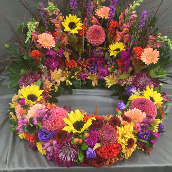 Colorful floral wreath with sunflowers, daisies, and mixed blooms