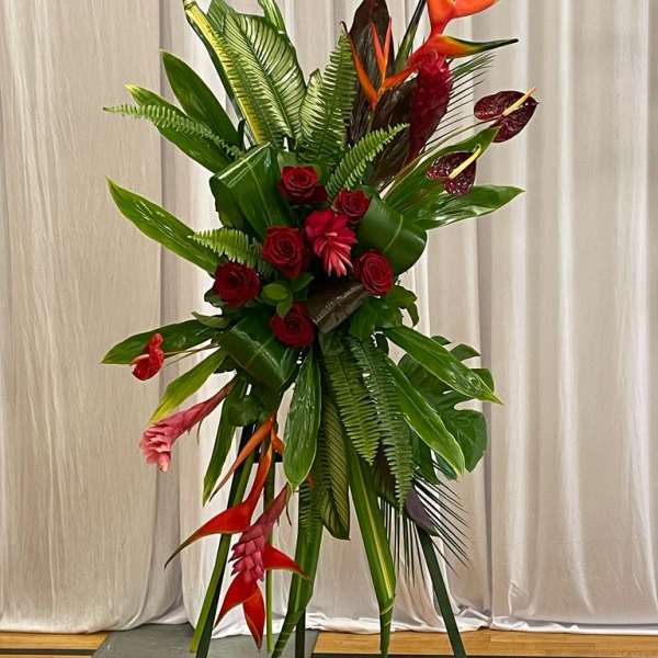 Tall tropical floral spray with red roses and orange heliconia
