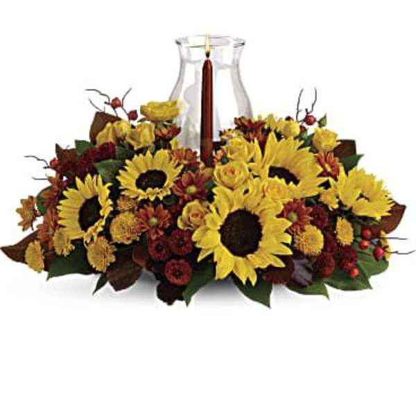 Sunflower and rose centerpiece with a glass candle holder