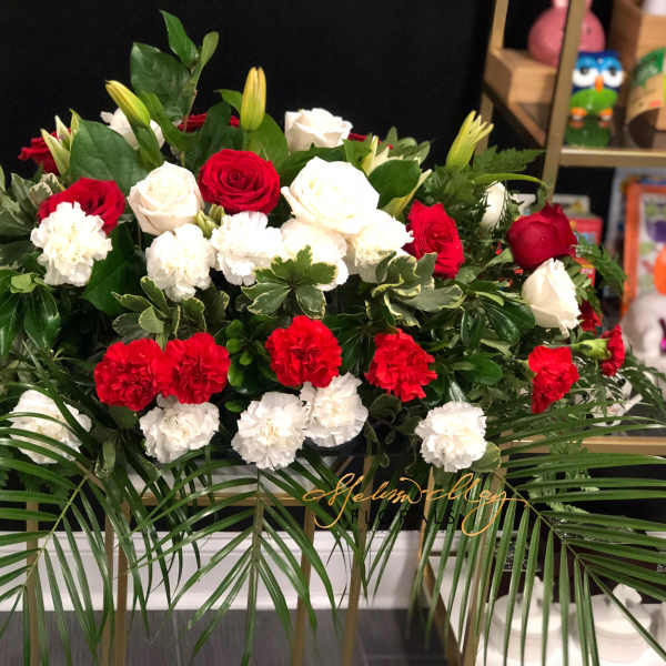 Red and white roses with carnations in a large floral arrangement