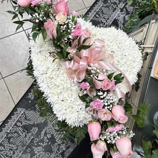 Heart-shaped white chrysanthemum wreath with pink roses and ribbon