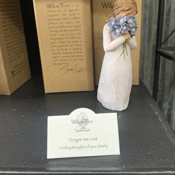 Small Willow Tree figurine holding blue flowers, displayed with its box