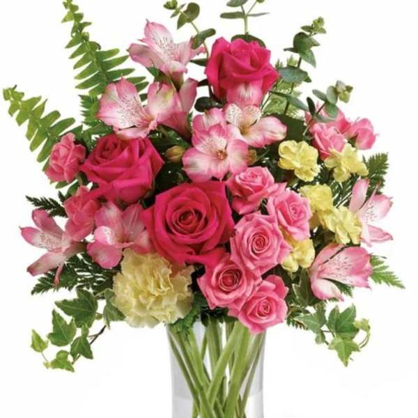 Pink roses and alstroemeria in a clear glass vase