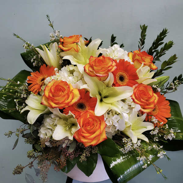 Bouquet of orange roses, white lilies, and orange gerbera daisies