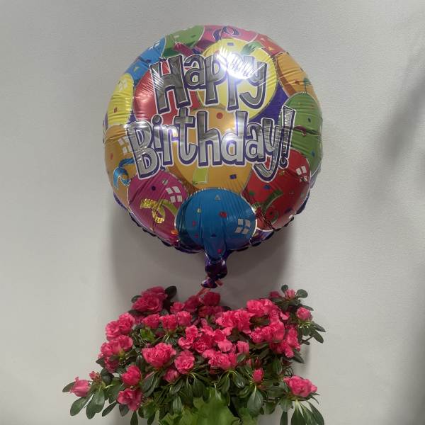 Birthday balloon above pink flowers and a Ferrero Rocher chocolate box