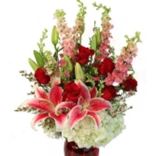 Red roses and pink lilies in a red vase
