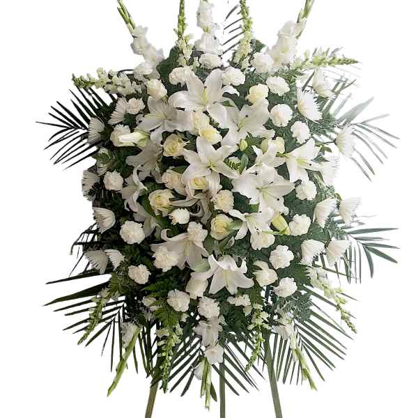 White funeral spray with lilies, roses, and carnations on a standing easel