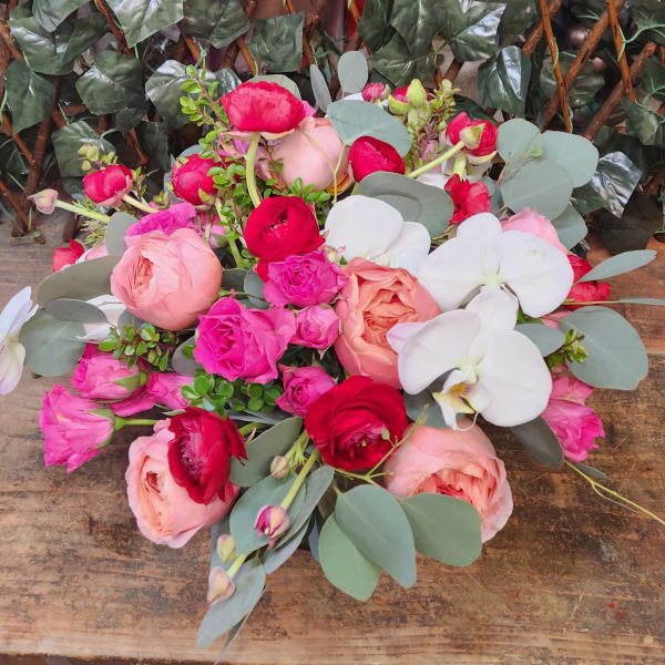 Mixed bouquet of pink and red roses with white orchids