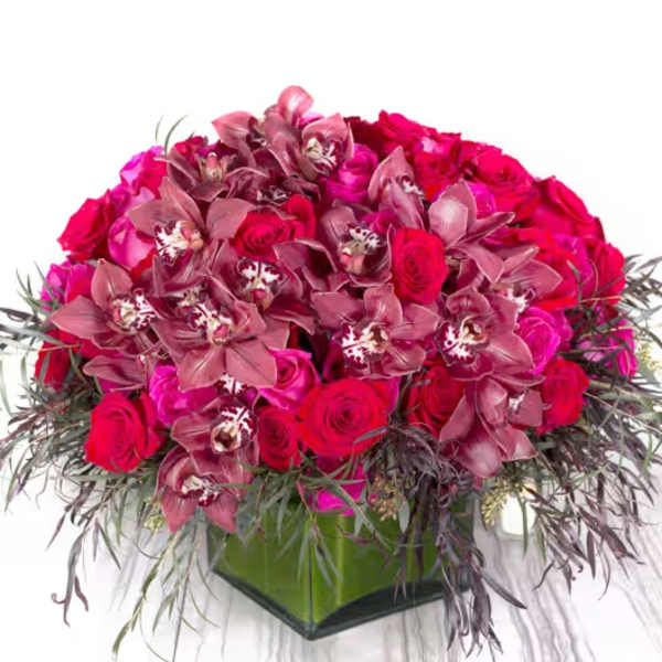 Pink and red rose arrangement with orchids in a square vase