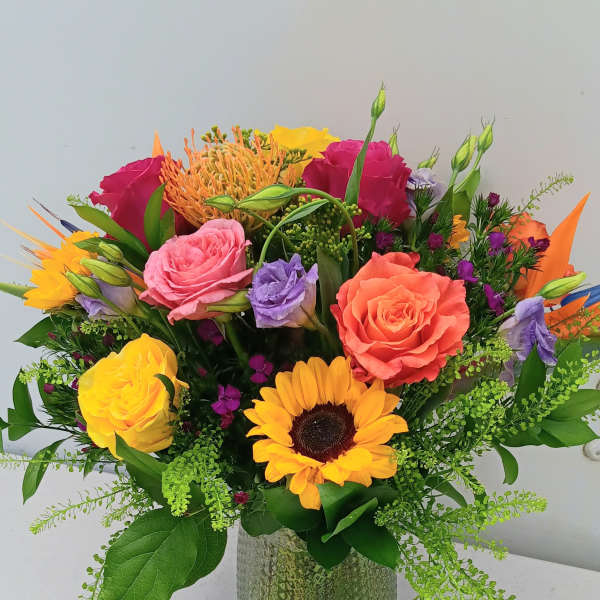 Colorful mixed bouquet in a textured glass vase