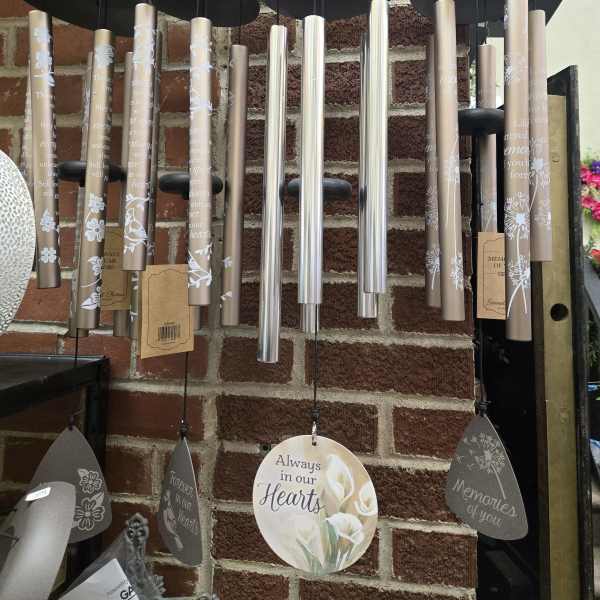 Hanging memorial wind chimes with engraved tubes and heart-shaped tags