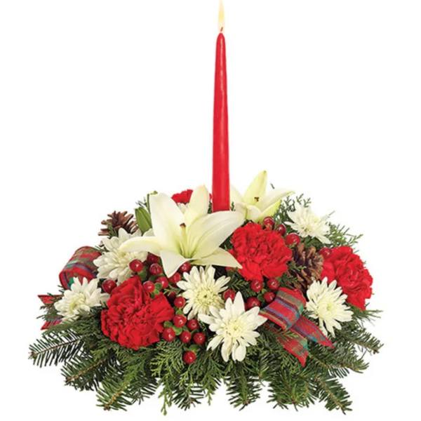 Holiday centerpiece with red candle, white lilies, and red-and-white flowers