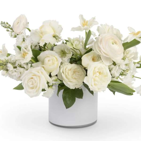 White floral arrangement in a white cylindrical vase
