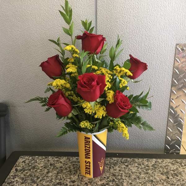 Red roses and yellow filler flowers in an Arizona State cup