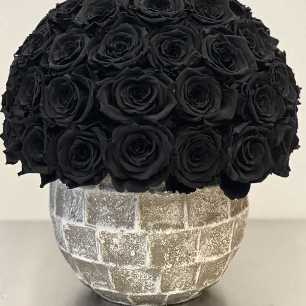 Black rose bouquet in a textured silver vase