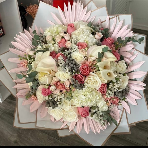 Large bouquet of pink and white roses with calla lilies