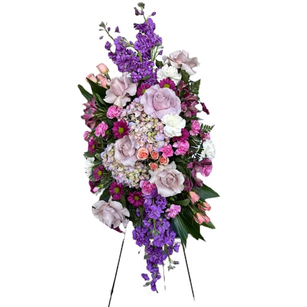 Tall standing floral spray with purple, pink, and white blooms