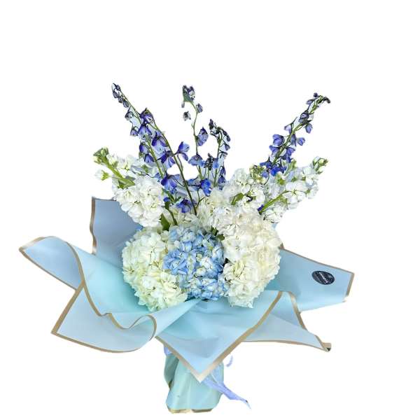 Bouquet of white and blue flowers wrapped in light blue paper