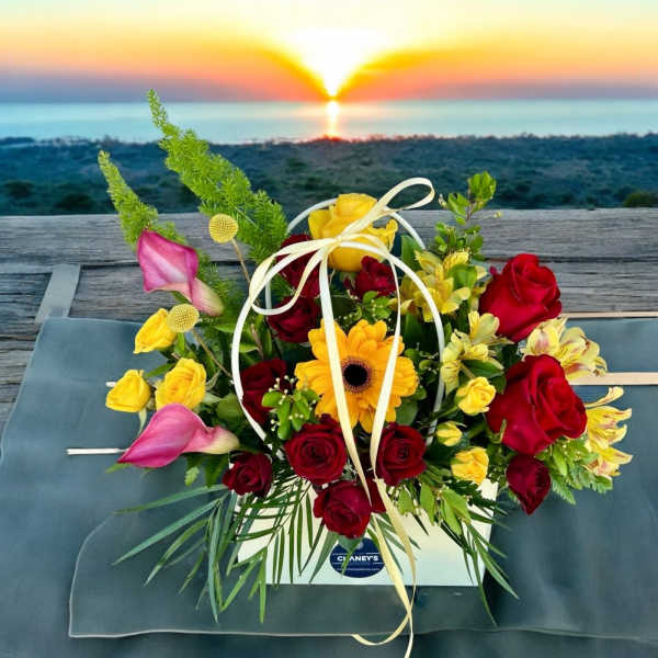 Mixed bouquet of red and yellow roses with calla lilies in a white box