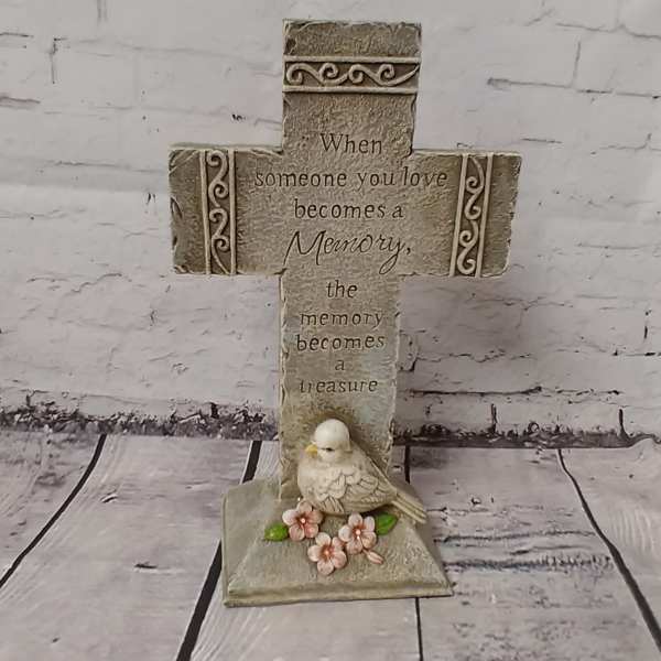 Decorative memorial cross with a bird and flowers