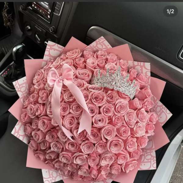 Large bouquet of pink roses with a satin bow and tiara